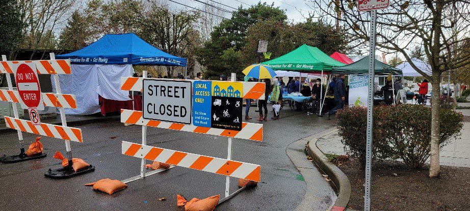 Tents set up behind a "Street Closed" sign