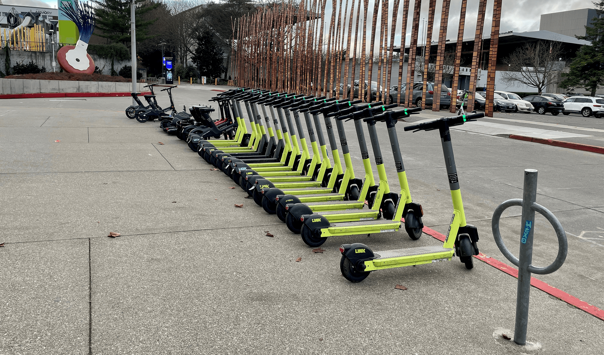 View of scooter share equipment lined up near the Seattle Center and the Museum of Popular Culture (MoPOP).