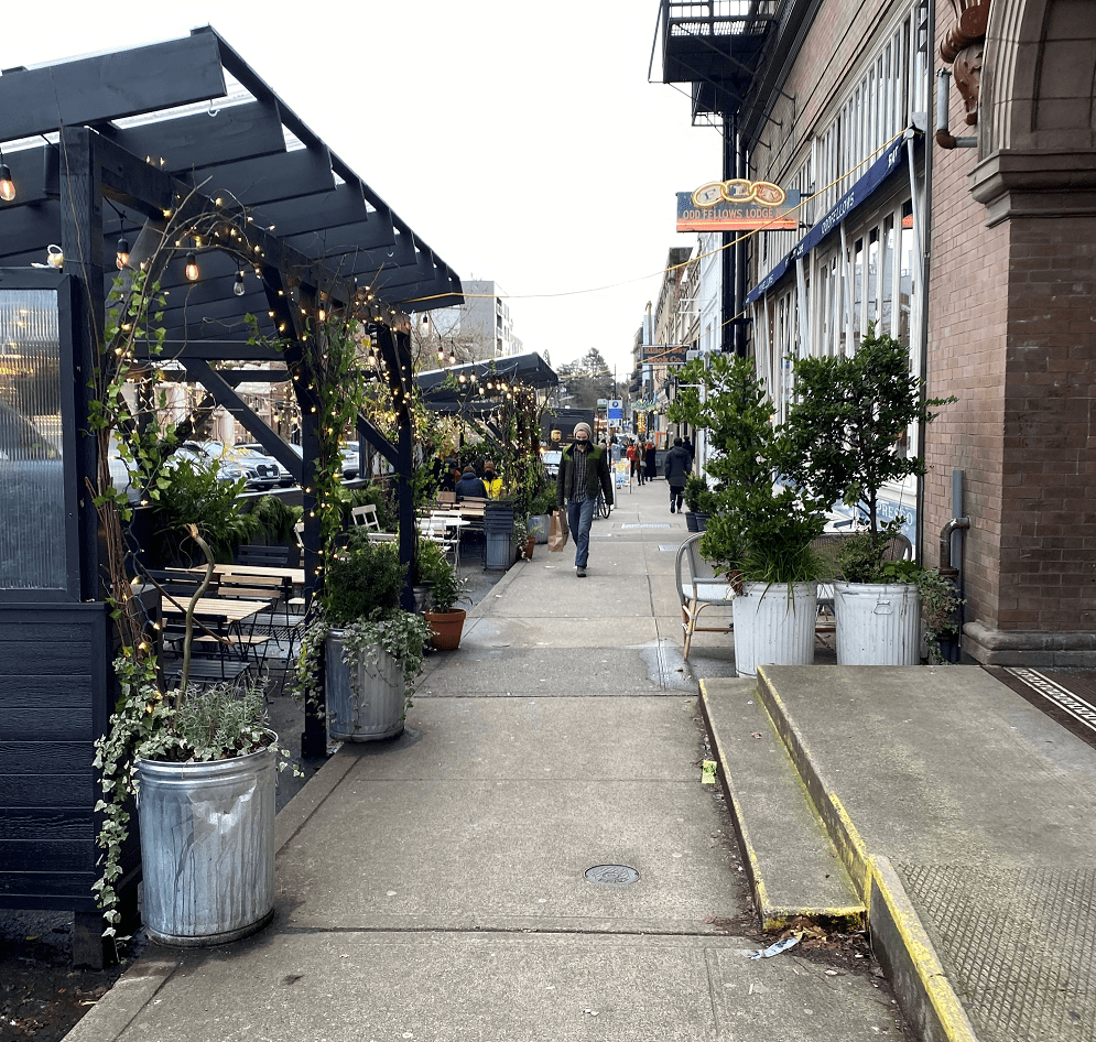 Photo of an outdoor eating area in front of Oddfellows Cafe in Seattle's Capitol Hill neighborhood.