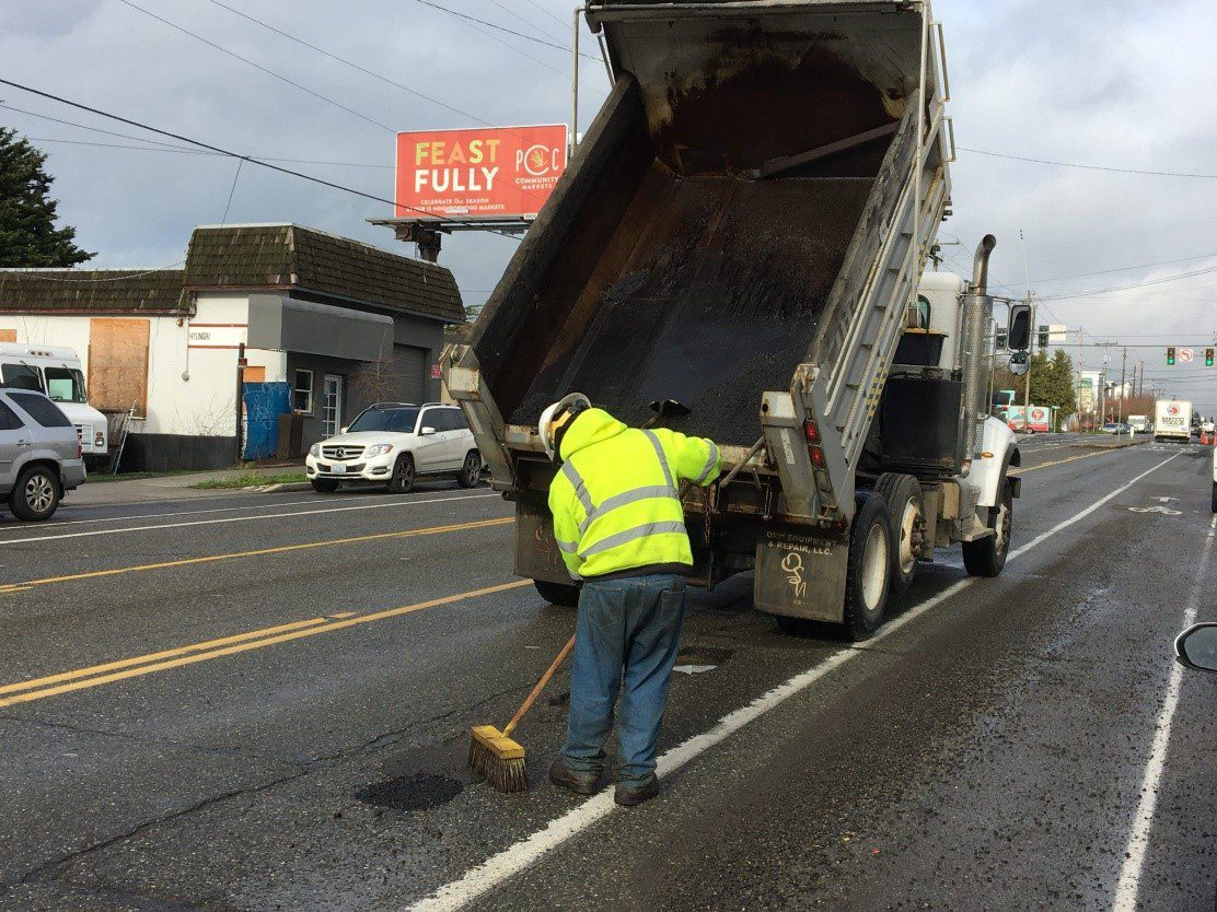 SDOT crews filling several potholes on Greenwood Ave N near N 100th St on Thursday, January 13, 2022. 