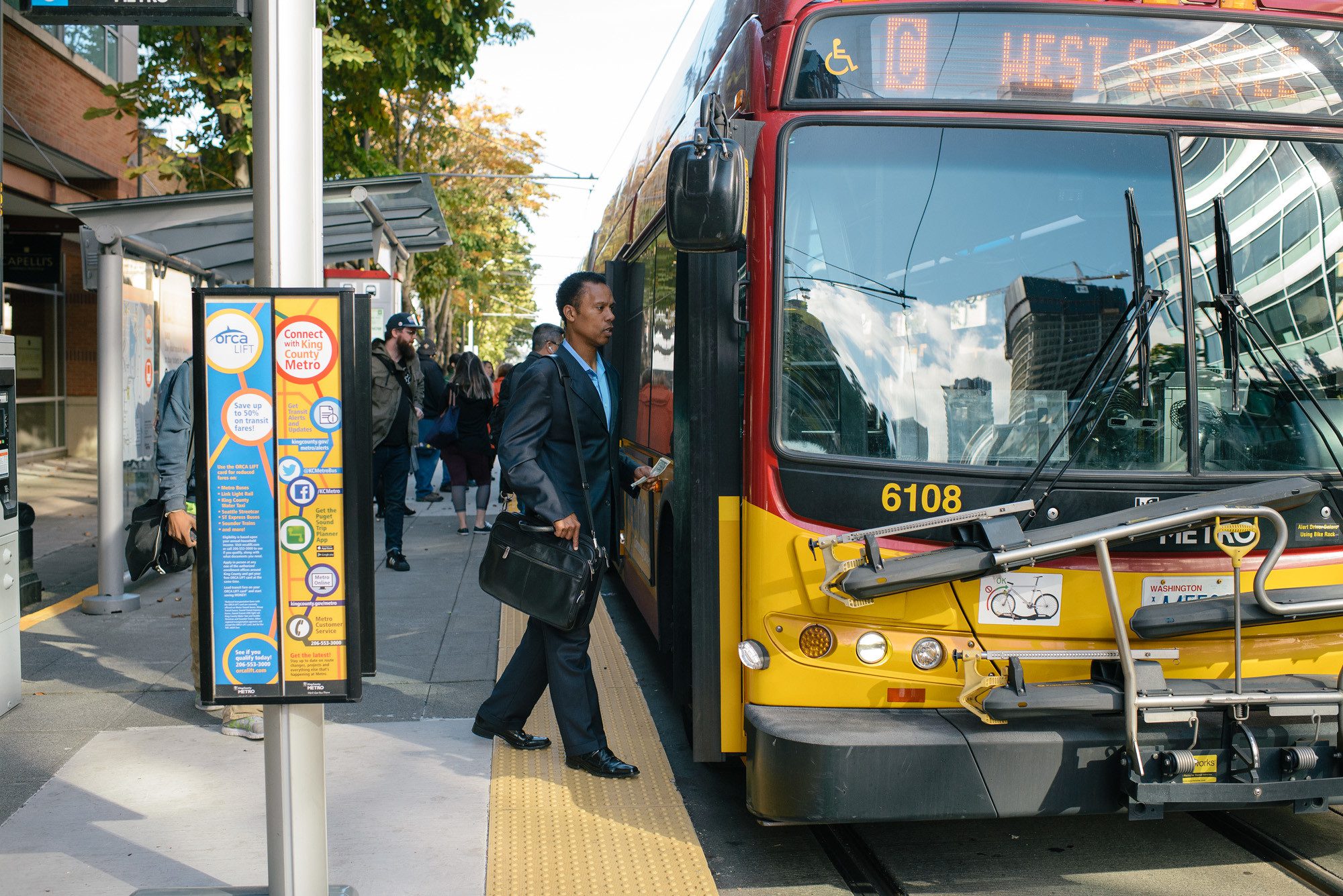 A man steps aboard a RapidRide bus in Seattle.
