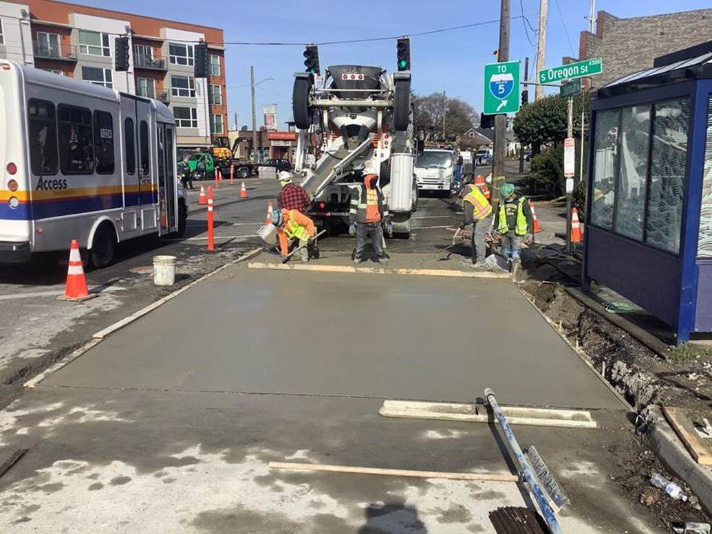 Workers pave a new bus lane.