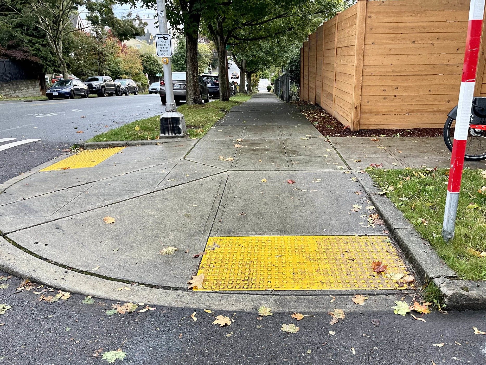 Example of a newly installed curb ramp in Seattle’s Central District that meets accessibility standards established by the Americans with Disabilities Act (ADA). The curb ramp allows people using wheelchairs or other mobility-assisting equipment to smoothly transition from the sidewalk down to the street in order to cross, and vice versa.