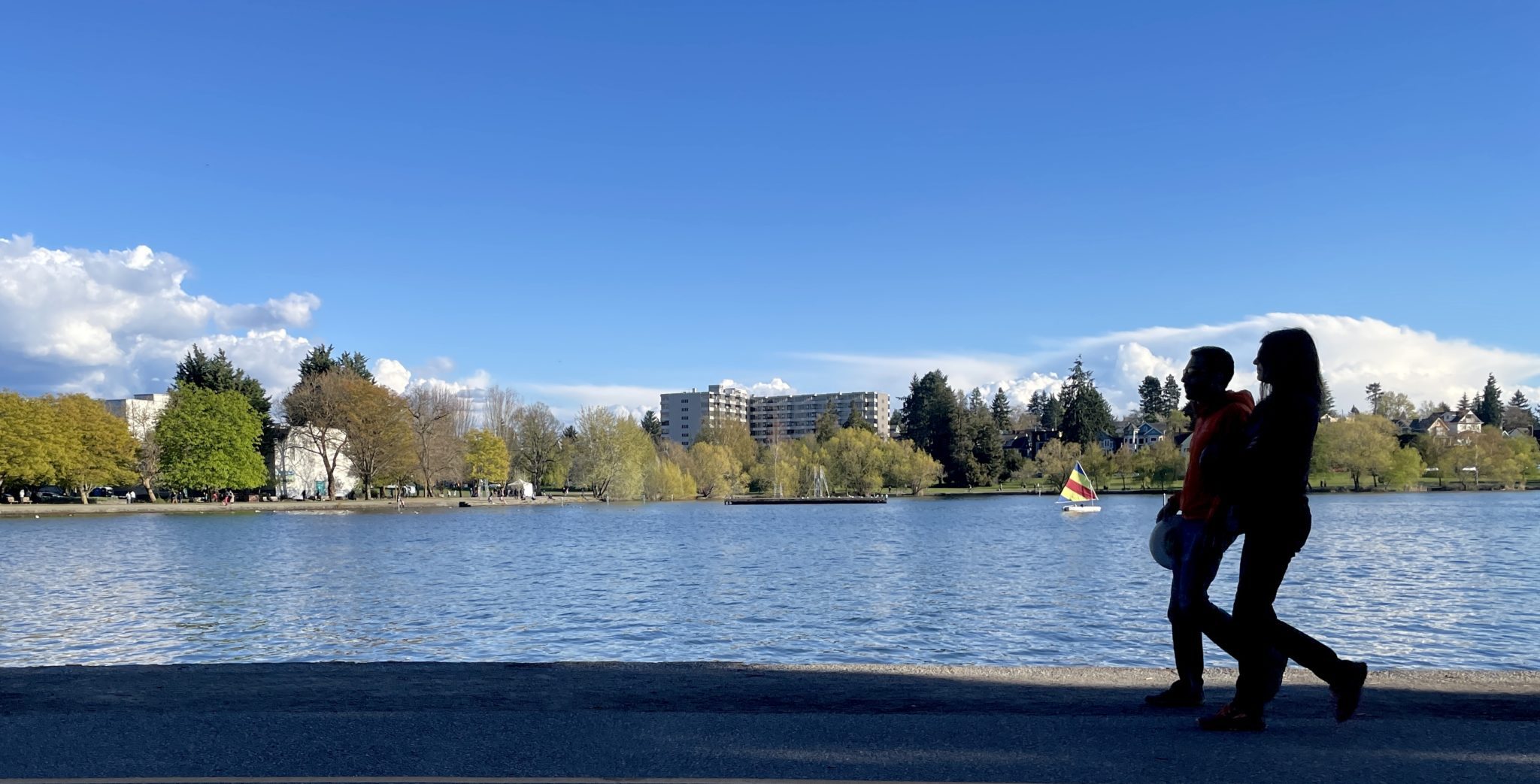 Two people walk around Green Lake Park in north Seattle.