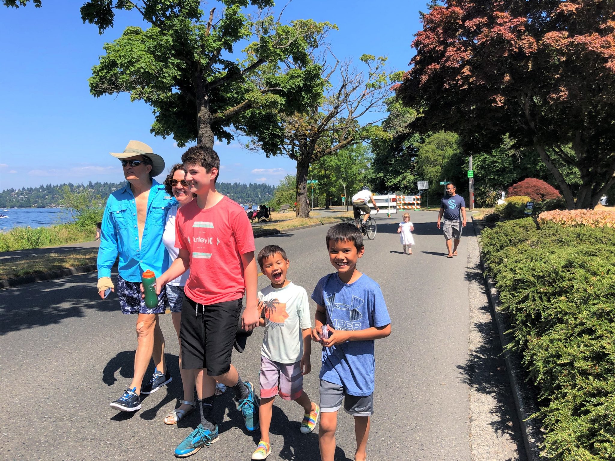 A family walks along Lake Washington Blvd during a summer street closure in 2021.