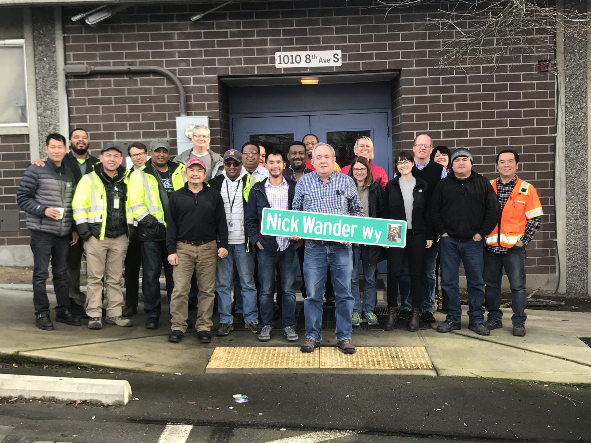 SDOT’s Curbside Management team gathers to celebrate Nick Wander’s retirement (pre-pandemic). Fred is visible to the left of Nick (behind the commemorative street sign).