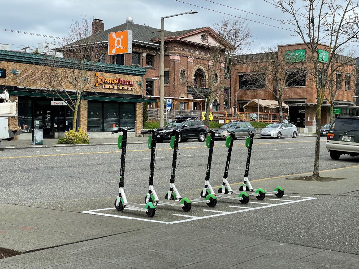 Lime scooters parked along a street in Ballard.