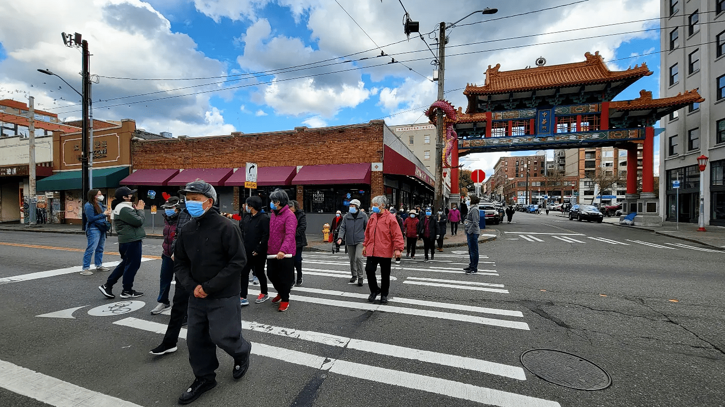 People cross the street in the Chinatown-International District neighborhood.