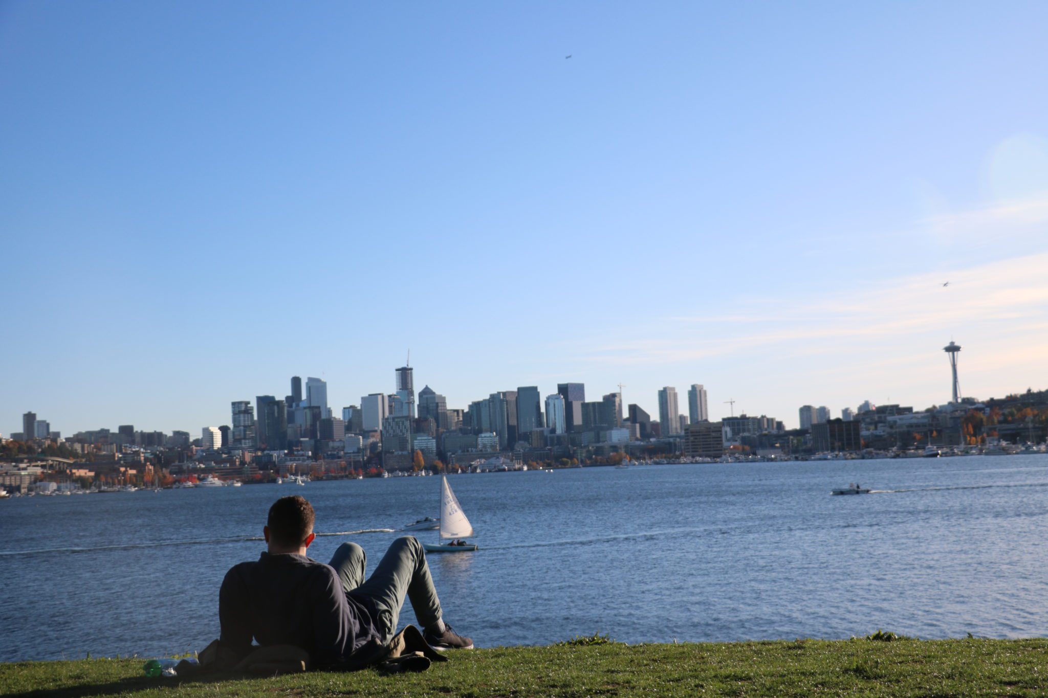 A person taking in the view of downtown Seattle from Gas Works Park.