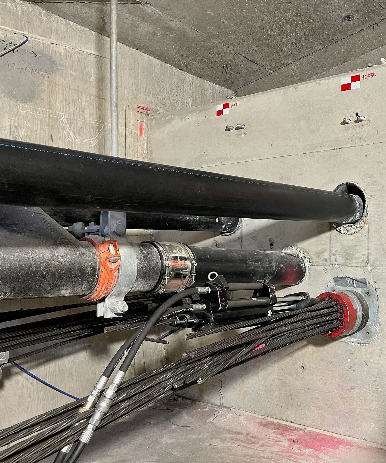 Photo of steel cables used for bridge post-tensioning in the West Seattle Bridge. The photo also includes protective pipes that hold the cables, inside the bridge.