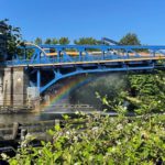 The Fremont Bridge receives a water spray down during last summer’s heat wave, causing a rainbow to appear between the bridge and the water.