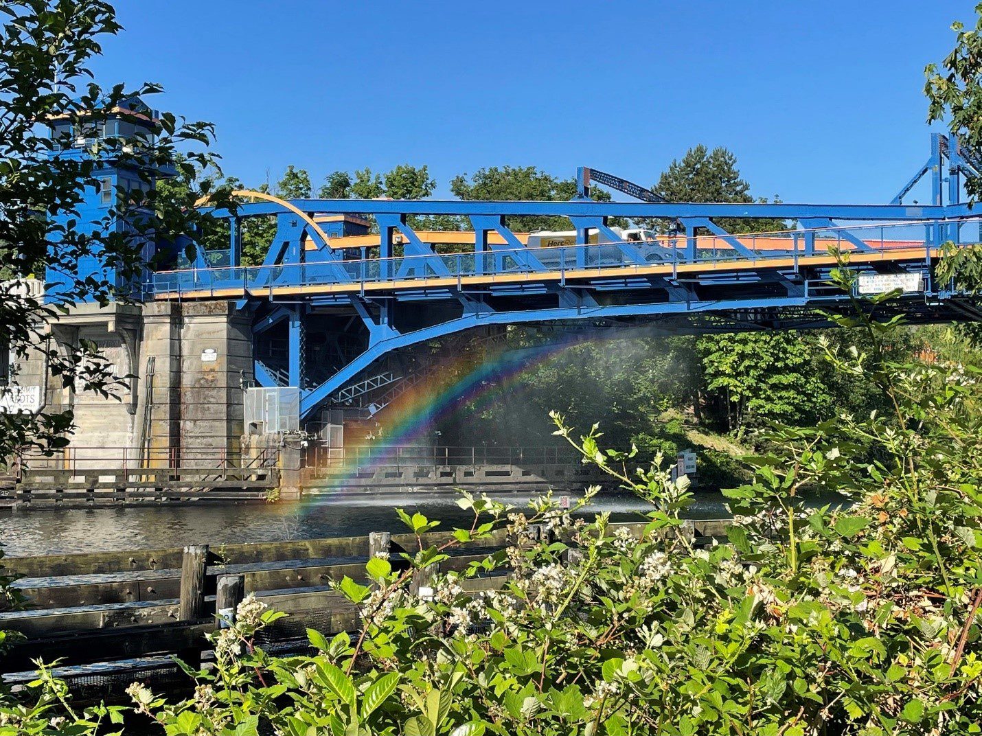 The Fremont Bridge receives a water spray down during last summer’s heat wave, causing a rainbow to appear between the bridge and the water.