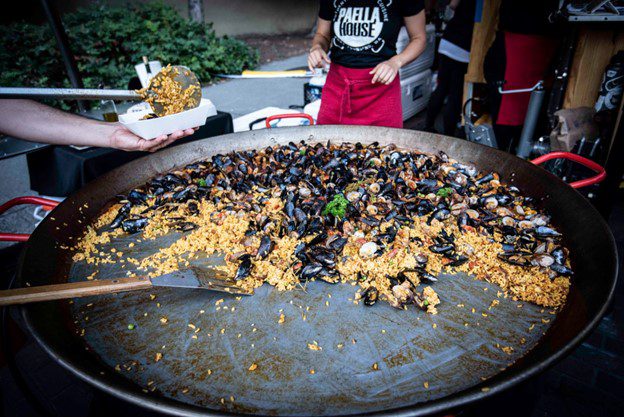 Serving mussels and rice at a past Ballard SeafoodFest.