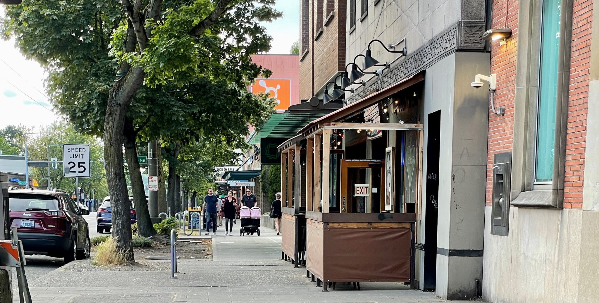 Street trees and a street café on NW Market St in Ballard.