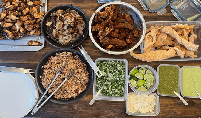 Typical Seahawks Sunday Enciso family authentic homemade meal. A variety of foods are laid out on a table, ready to be eaten.