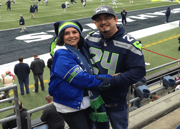 Dahvee and his mother Eva at a Seattle Seahawks game. The field is visible in the background.