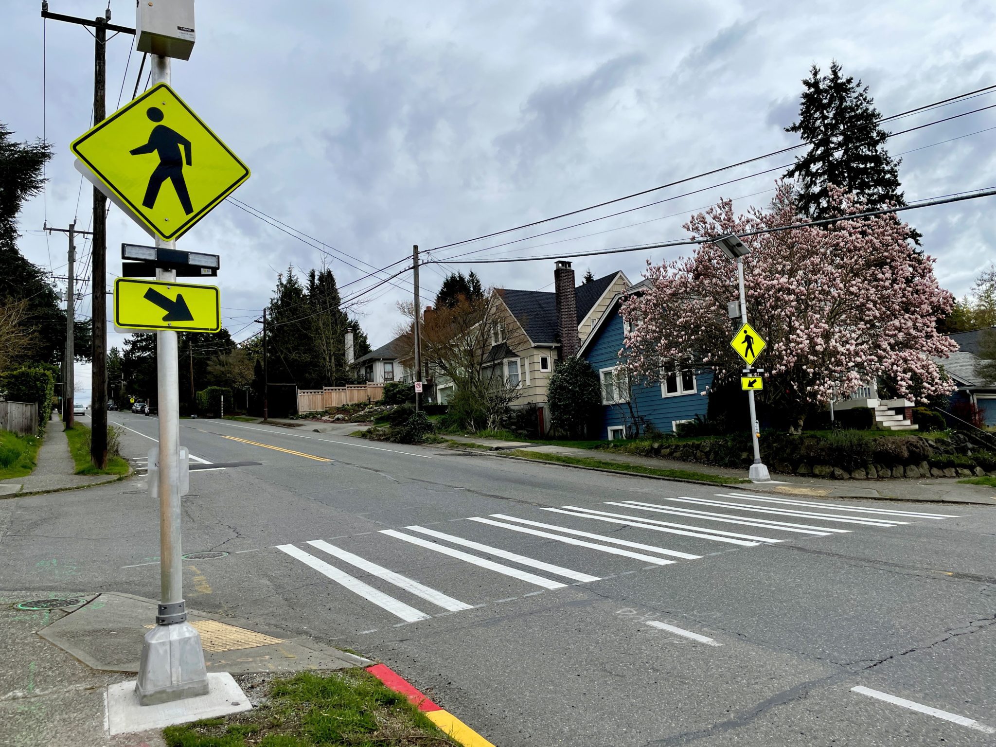 An image of a Rectangular Rapid Flashing Beacon. Flashing beacons are present on either side of the crosswalk that can be triggered by a pedestrian prior to crossing to raise awareness for drivers that someone is crossing. 