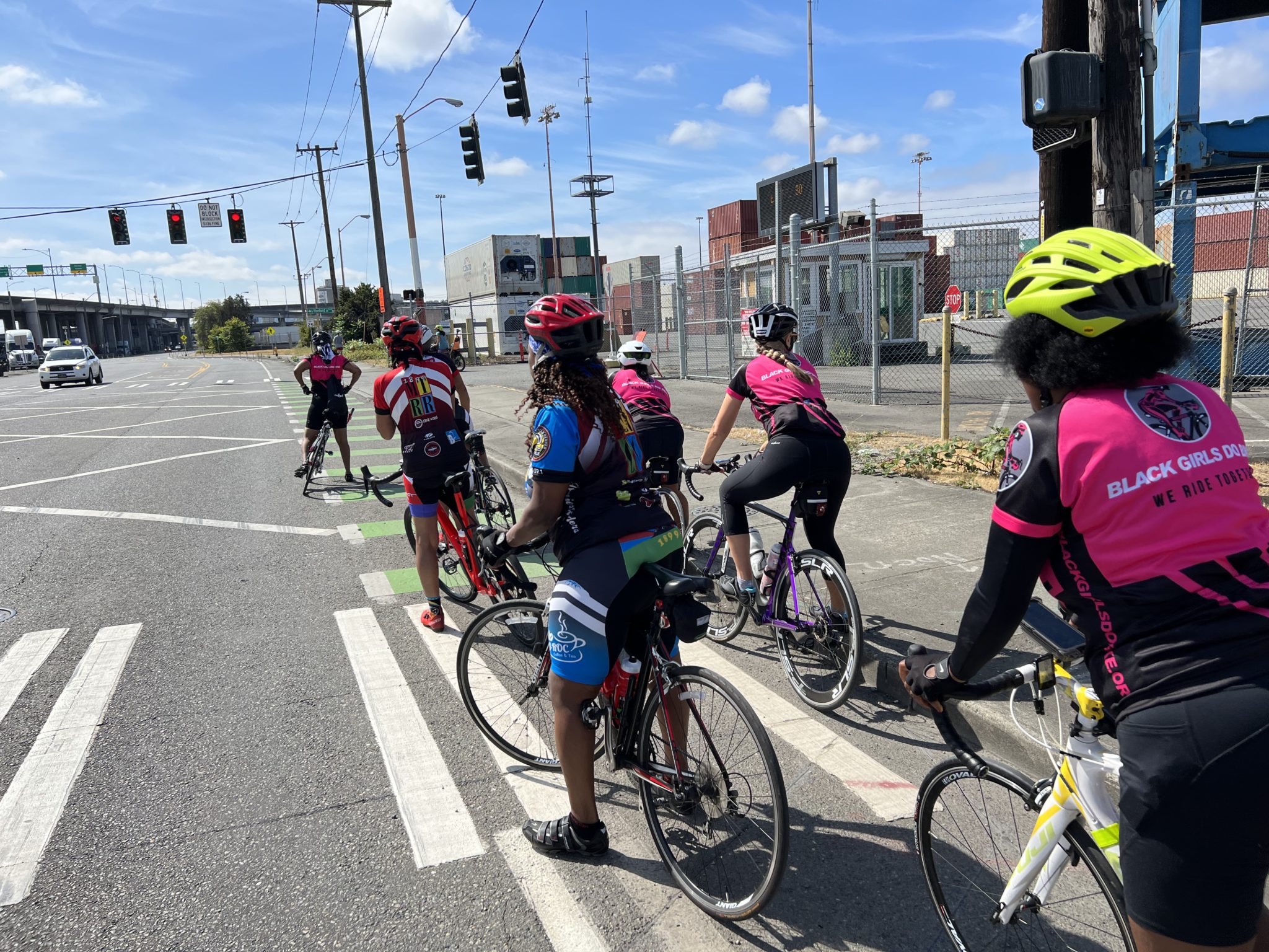 Cyclists with Black Girls Do Ride and the Rainier Riders use a bike lane to cross the street.