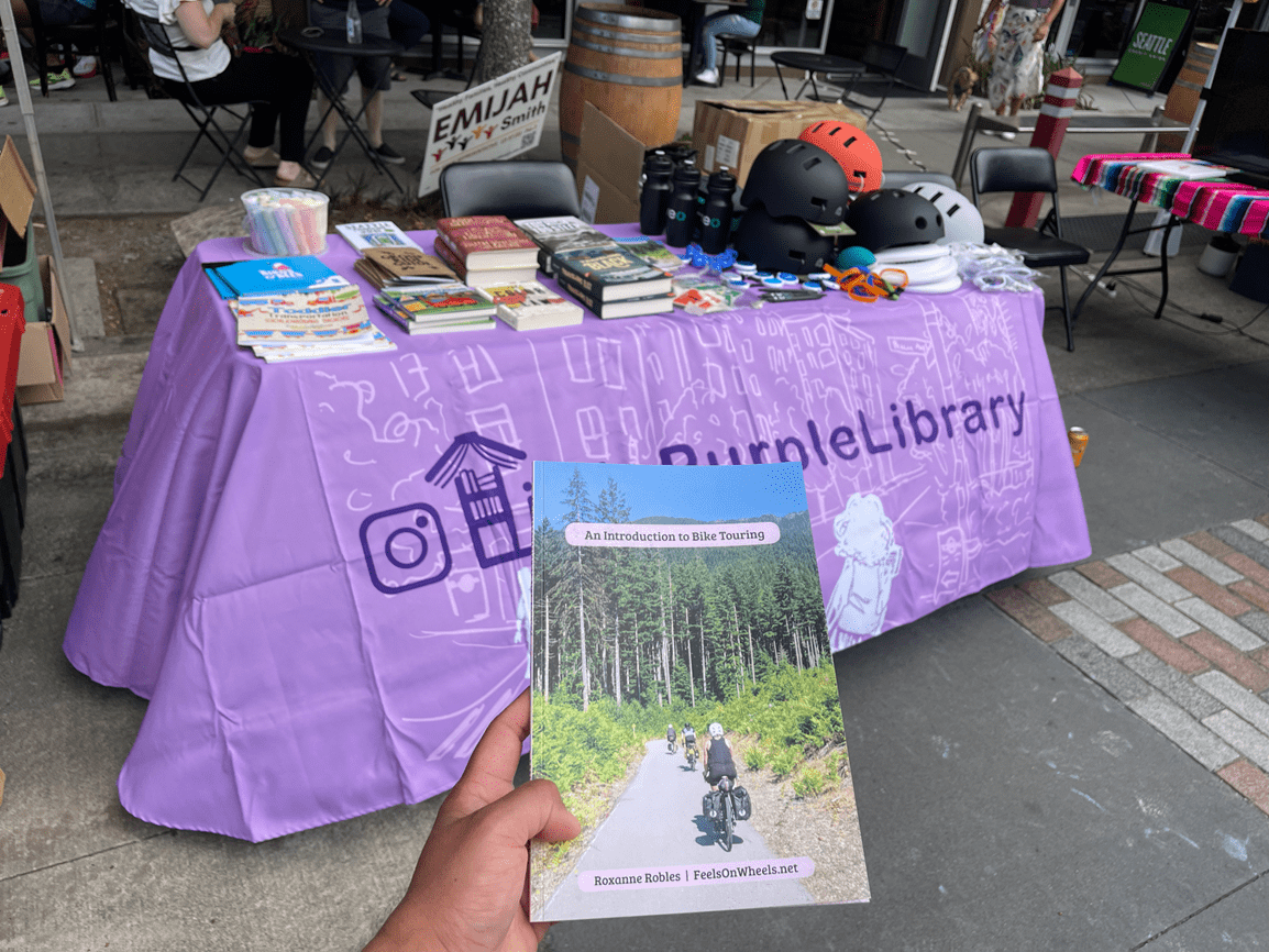 Table at the August Beacon Arts Street Fair. The book pictured close to the camera is authored by local resident Roxy Robles. Photo Credit: Yes Segura.