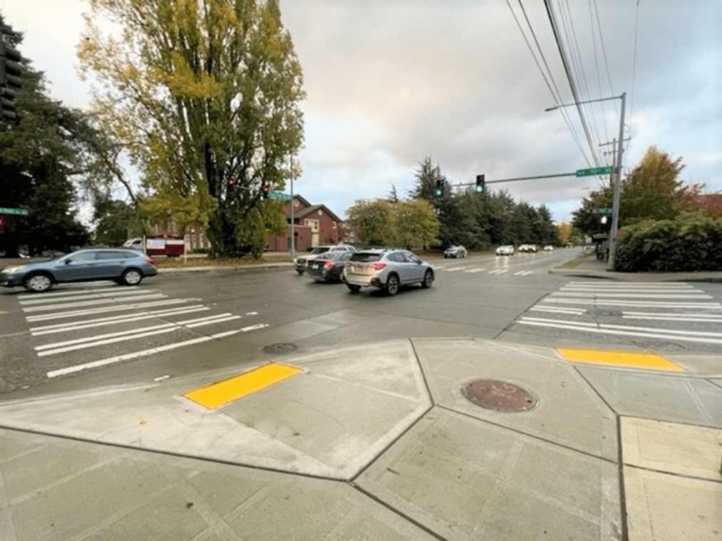 New ADA curb ramps and sidewalk at NE 70th St and on Sand Point Way NE. Photo Credit: SDOT.