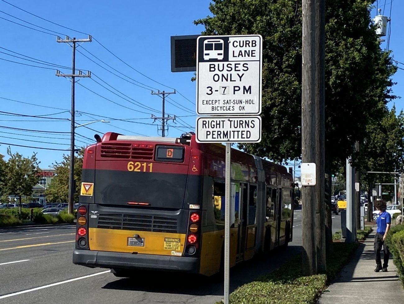 A bus travels in the existing curb lane on 15th Ave W. When not restricted to buses only, the curb lane is used for parking and loading access. Photo credit: SDOT 