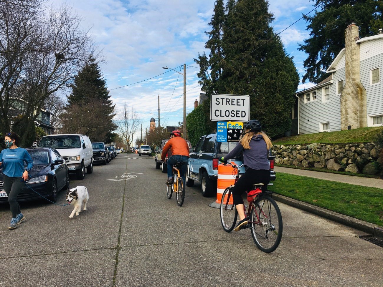 People enjoy riding bikes and jogging with their dog on a Healthy Street in 2021. Photo: SDOT. 