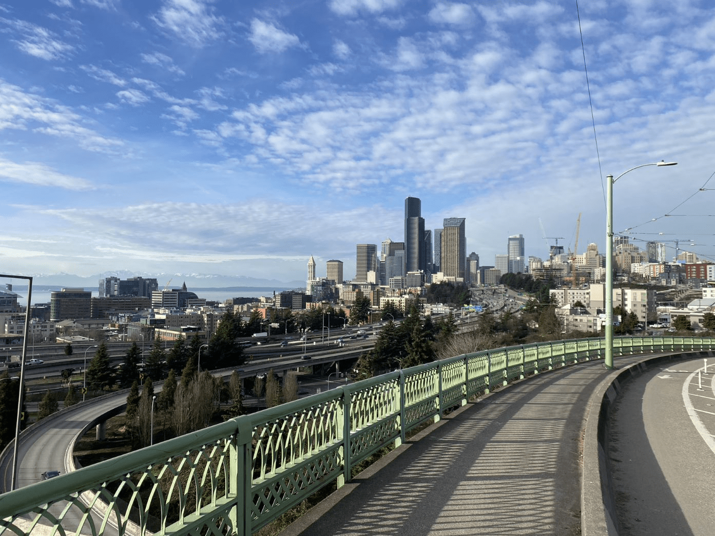 A photo taken from the pedestrian pathway on the Jose Rizal Bridge over S Dearborn Street facing north toward downtown Seattle
