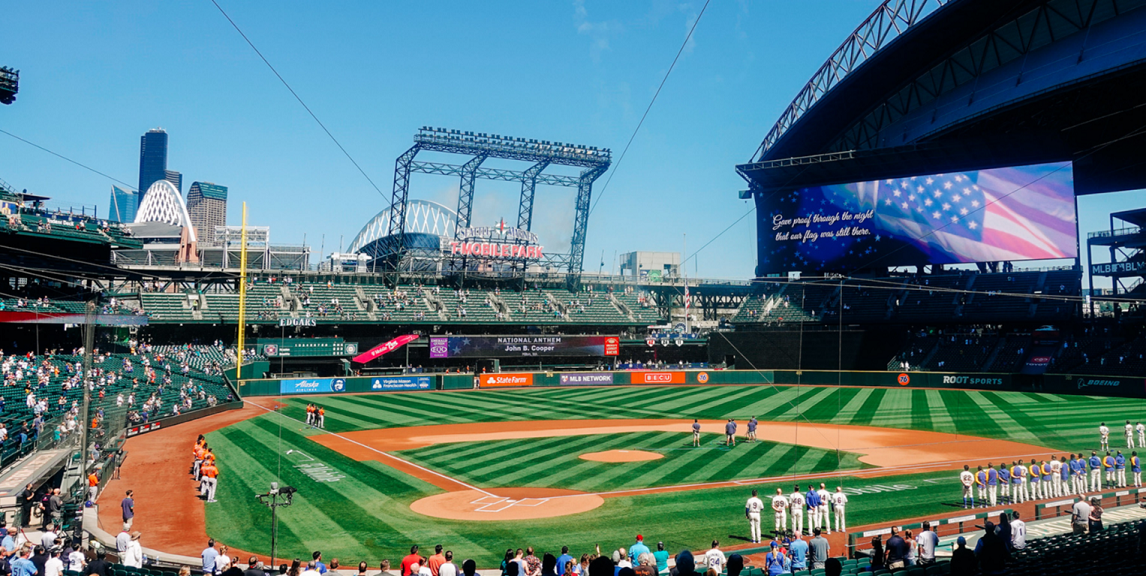 A wide angle view of a baseball field on a sunny day.