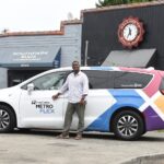 A Metro Flex driver smiles while parked next to South Park Suds Laundromat. Photo credit: King County Metro 