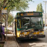 A bus at a bus stop, with the display reading "40 Fremont". People get ready to board the bus.