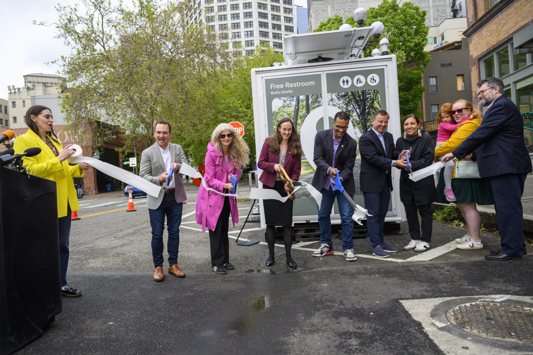 Ribbon cutting event in front of new restrooms in Pioneer Square.